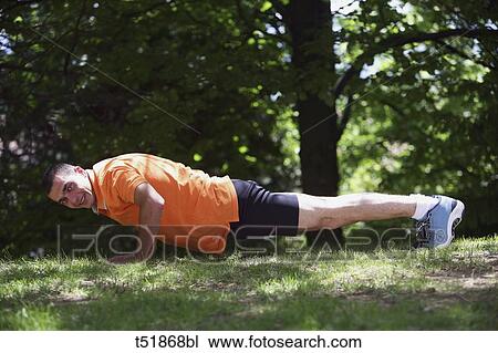 Man doing push-ups outdoors View Large Photo Image Stock Image - Man doing push-ups outdoors . Fotosearch