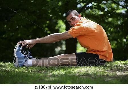Man stretching outdoors View Large Photo Image Stock Image - Man stretching outdoors . Fotosearch