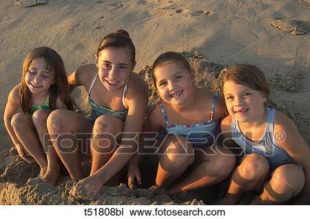 Stock Image - Portrait of a group of girls at beach . Fotosearch