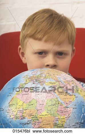 portrait of little boy hiding behind globe made of jigsaw pieces View Large Photo Image Stock Image - portrait of little boy hiding behind globe made of jigsaw pieces. Fotosearch