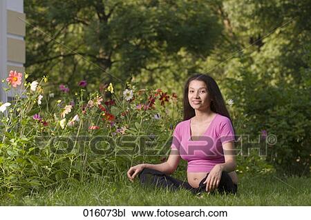 portrait of pregnant young woman sitting on meadow in park View Large Photo Image Stock Image - portrait of pregnant young woman sitting on meadow in park. Fotosearch