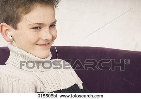 portrait of smiling young boy with earphones View Large Photo Image Stock Image - portrait of smiling young boy with earphones. Fotosearch