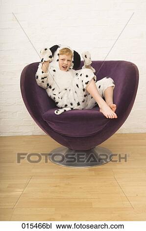 portrait of sulking boy in dalmatian dog costume sitting in purple arm chair View Large Photo Image Stock Image - portrait of sulking boy in dalmatian dog costume sitting in purple arm chair. Fotosearch