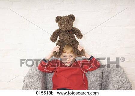 portrait of young boy holding teddy bear over his head View Large Photo Image Stock Image - portrait of young boy holding teddy bear over his head. Fotosearch