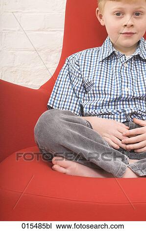 portrait of young boy sitting in arm chair View Large Photo Image Stock Image - portrait of young boy sitting in arm chair. Fotosearch