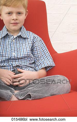 portrait of young boy sitting in arm chair View Large Photo Image Stock Image - portrait of young boy sitting in arm chair. Fotosearch