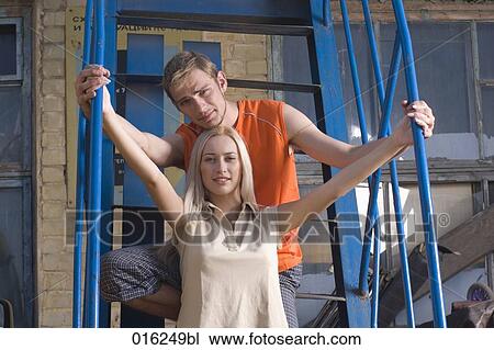 Stock Image - portrait of young couple standing on stairs. Fotosearch