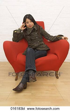 portrait of young japanese woman sitting in red arm chair View Large Photo Image Stock Image - portrait of young japanese woman sitting in red arm chair. Fotosearch