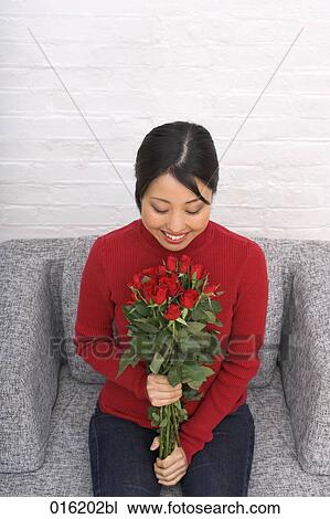 portrait of young japanese woman holding bouquet of red roses View Large Photo Image Stock Image - portrait of young japanese woman holding bouquet of red roses. Fotosearch