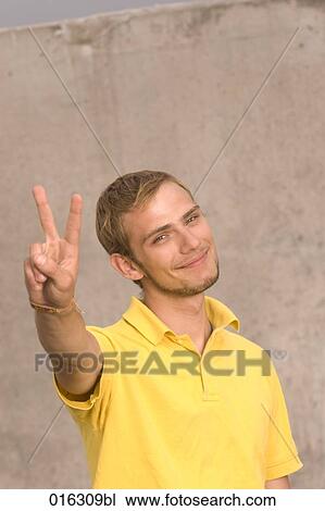portrait of young man doing the victory sign View Large Photo Image Stock Image - portrait of young man doing the victory sign. Fotosearch