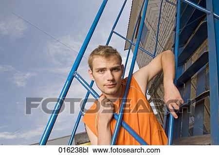 portrait of young man looking through railing View Large Photo Image Stock Image - portrait of young man looking through railing. Fotosearch
