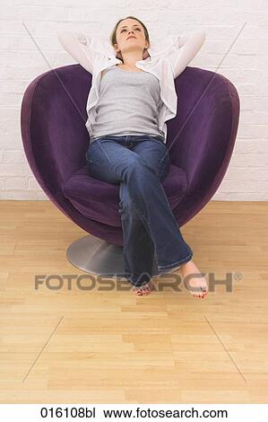 portrait of young woman leaning back in arm chair View Large Photo Image Stock Image - portrait of young woman leaning back in arm chair. Fotosearch