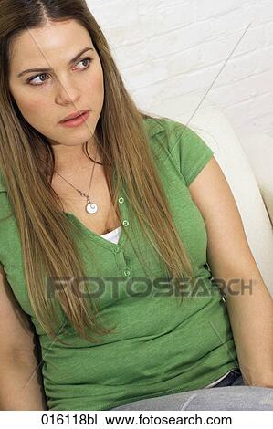 Stock Image - portrait of young woman looking insecure. Fotosearch