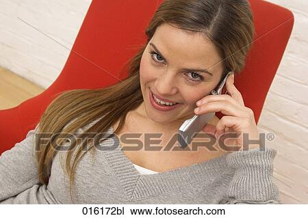 Stock Image - portrait of young woman with mobile phone. Fotosearch
