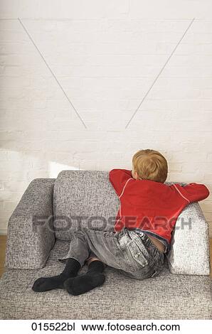 rear view of young boy sitting in arm chair View Large Photo Image Stock Image - rear view of young boy sitting in arm chair. Fotosearch