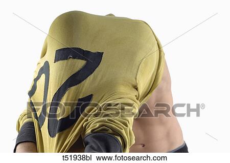 Stock Image - Rugby player taking off his shirt . Fotosearch