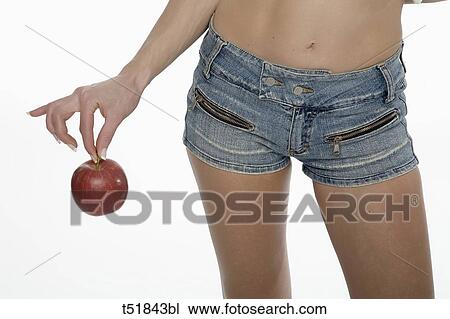Stock Image - Sexy woman holding apple . Fotosearch