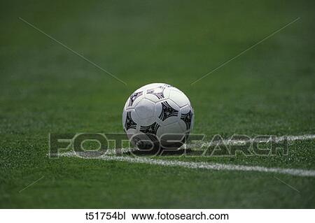 Stock Image - Soccer ball in field . Fotosearch