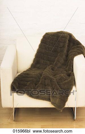 still life brown blanket on white arm chair View Large Photo Image Stock Image - still life brown blanket on white arm chair. Fotosearch