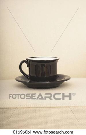 still life of black coffee cup on white arm chair View Large Photo Image Stock Image - still life of black coffee cup on white arm chair. Fotosearch