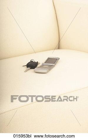 still life of car key and mobile phone on white arm chair View Large Photo Image Stock Image - still life of car key and mobile phone on white arm chair. Fotosearch