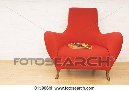 still life of colourful toy xylophone on red arm chair View Large Photo Image Stock Image - still life of colourful toy xylophone on red arm chair. Fotosearch