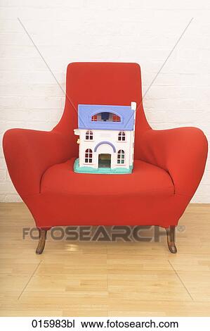 still life of miniature house on red arm chair View Large Photo Image Stock Image - still life of miniature house on red arm chair. Fotosearch