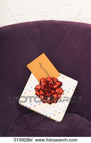 still life of of present with english note happy birthday on arm chair View Large Photo Image Stock Image - still life of of present with english note happy birthday on arm chair. Fotosearch