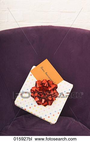 still life of of present with french note bonne anniversaire on arm chair View Large Photo Image Stock Image - still life of of present with french note bonne anniversaire on arm chair. Fotosearch