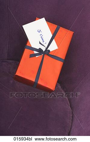 still life of of present with french note je t´aime on arm chair View Large Photo Image Stock Image - still life of of present with french note je t´aime on arm chair. Fotosearch