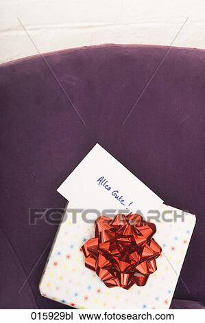 still life of of present with german note alles gute on arm chair View Large Photo Image Stock Image - still life of of present with german note alles gute on arm chair. Fotosearch