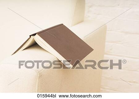 still life of open book on white arm chair View Large Photo Image Stock Image - still life of open book on white arm chair. Fotosearch
