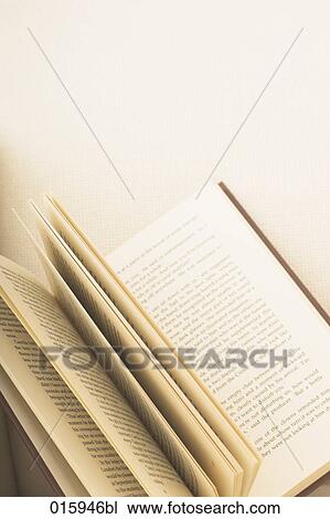 still life of open book on white arm chair View Large Photo Image Stock Image - still life of open book on white arm chair. Fotosearch