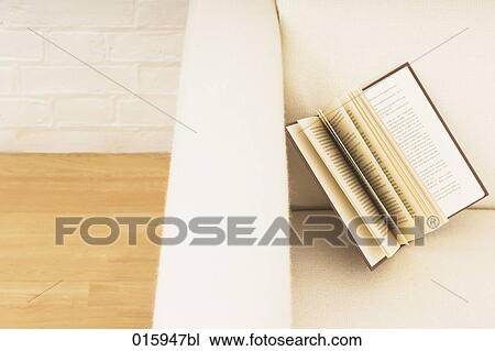 still life of open book on white arm chair View Large Photo Image Stock Image - still life of open book on white arm chair. Fotosearch
