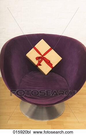 still life of present on purple arm chair View Large Photo Image Stock Image - still life of present on purple arm chair. Fotosearch