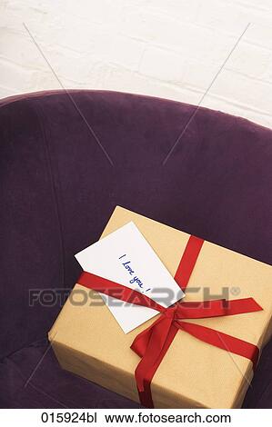 still life of present with english note i love you on purple arm chair View Large Photo Image Stock Image - still life of present with english note i love you on purple arm chair. Fotosearch