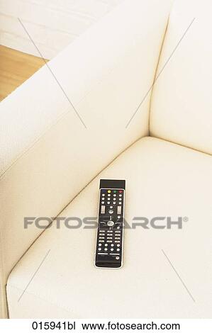still life of remote control on white arm chair View Large Photo Image Stock Image - still life of remote control on white arm chair. Fotosearch