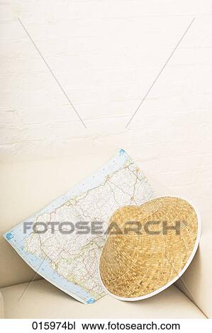 still life of straw hat and roadmap on white arm chair View Large Photo Image Stock Image - still life of straw hat and roadmap on white arm chair. Fotosearch