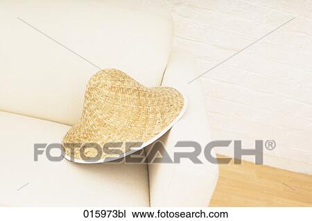 still life of straw hat on white arm chair View Large Photo Image Stock Image - still life of straw hat on white arm chair. Fotosearch