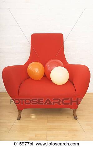 still life of three colourful balloons on red arm chair View Large Photo Image Stock Image - still life of three colourful balloons on red arm chair. Fotosearch