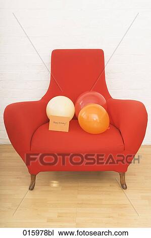 still life of three colourful balloons and english note happy birthday on red arm chair View Large Photo Image Stock Image - still life of three colourful balloons and english note happy birthday on red arm chair. Fotosearch