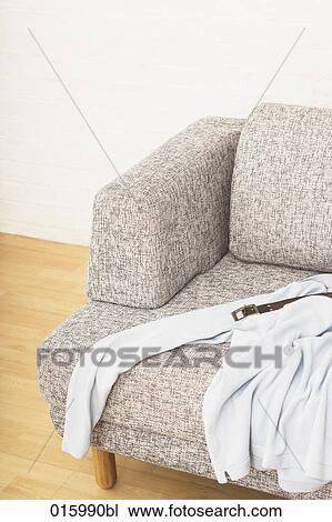 still life of white t-shirt and belt on grey arm chair View Large Photo Image Stock Image - still life of white t-shirt and belt on grey arm chair. Fotosearch