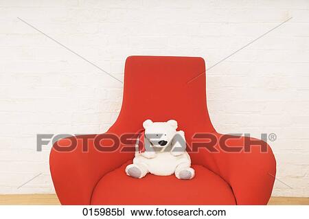 still life of white teddy bear sitting on red arm chair View Large Photo Image Stock Image - still life of white teddy bear sitting on red arm chair. Fotosearch