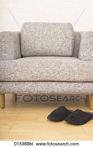 still life with pair of slippers in front of grey arm chair View Large Photo Image Stock Image - still life with pair of slippers in front of grey arm chair. Fotosearch