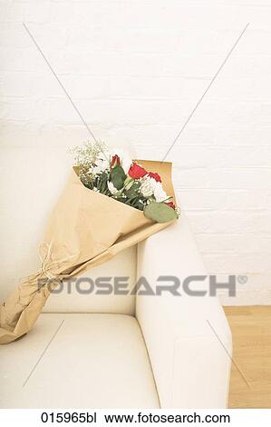 Stock Image - still of flower bouquet on arm chair. Fotosearch