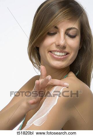 Woman applying moisturizer to shoulder View Large Photo Image Stock Image - Woman applying moisturizer to shoulder . Fotosearch