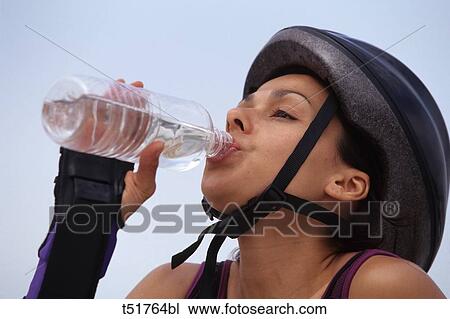 Woman drinking after exercising View Large Photo Image Stock Image - Woman drinking after exercising . Fotosearch