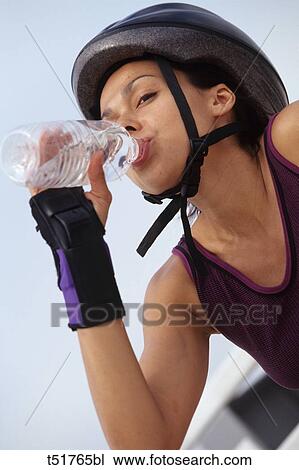 Woman drinking after exercising View Large Photo Image Stock Image - Woman drinking after exercising . Fotosearch