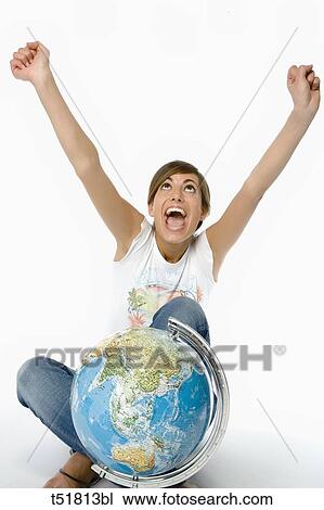 Stock Image - Woman hand raised and globe . Fotosearch