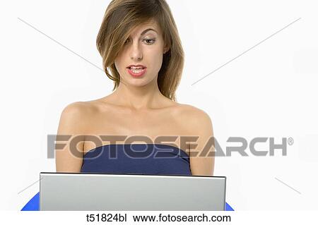 Woman on a chair working with laptop View Large Photo Image Stock Image - Woman on a chair working with laptop . Fotosearch